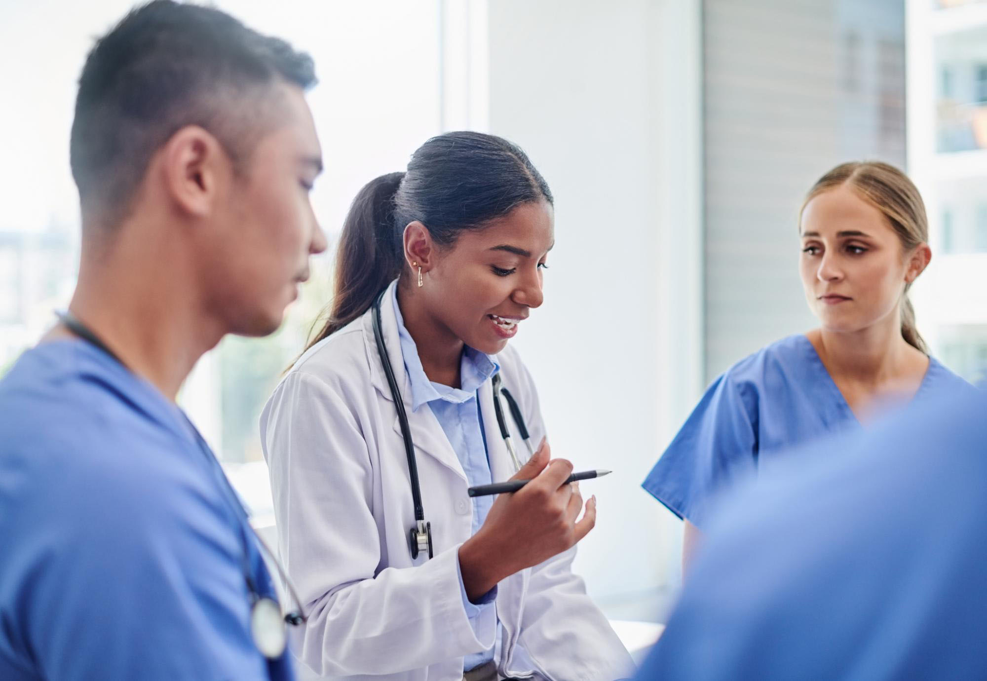 Healthcare professionals discussing patient notes together